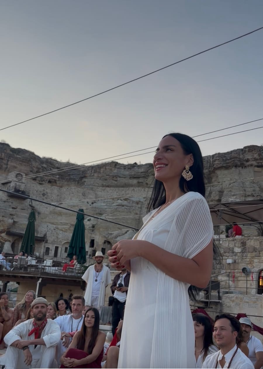Gem smiling among guests gathered outdoors at a retreat