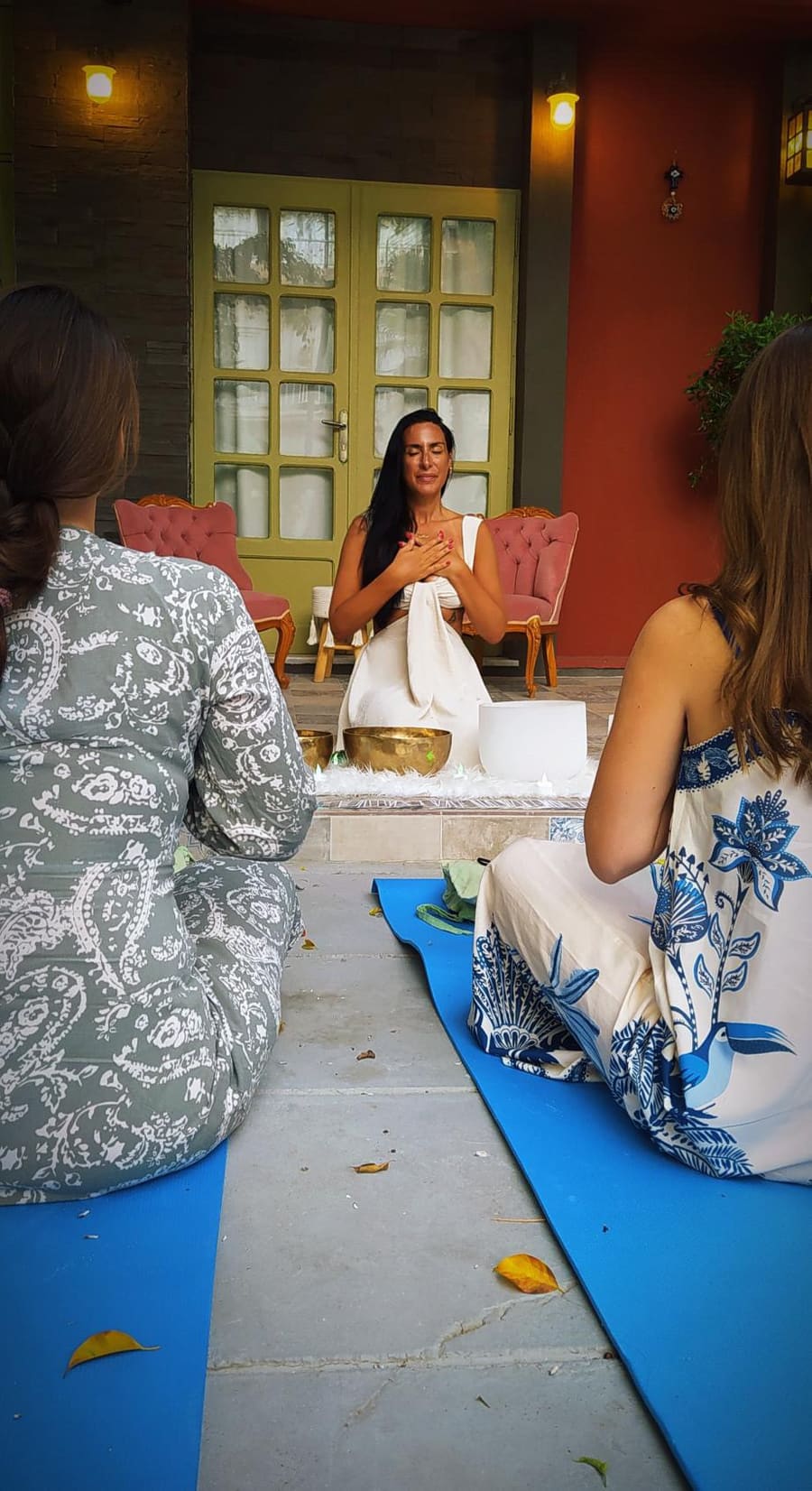 Gem opening a small group session on a courtyard terrace