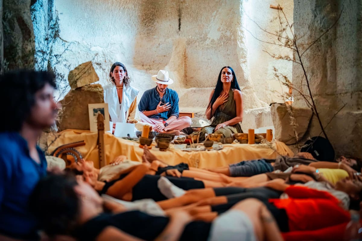 Participants resting as Gem holds a group sound ceremony in a rock chapel